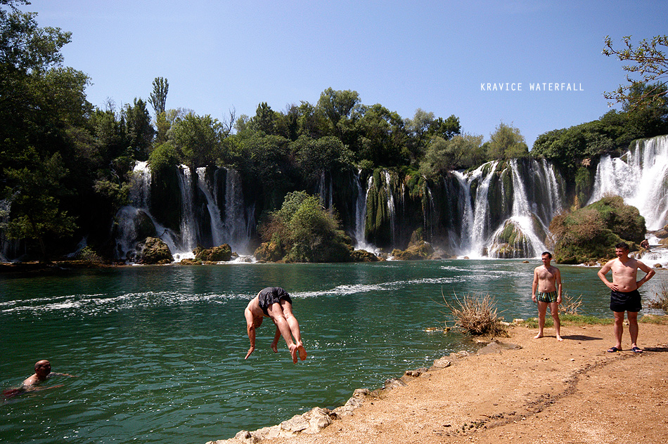 men diving in a waterfall in bosnia-herzegovina